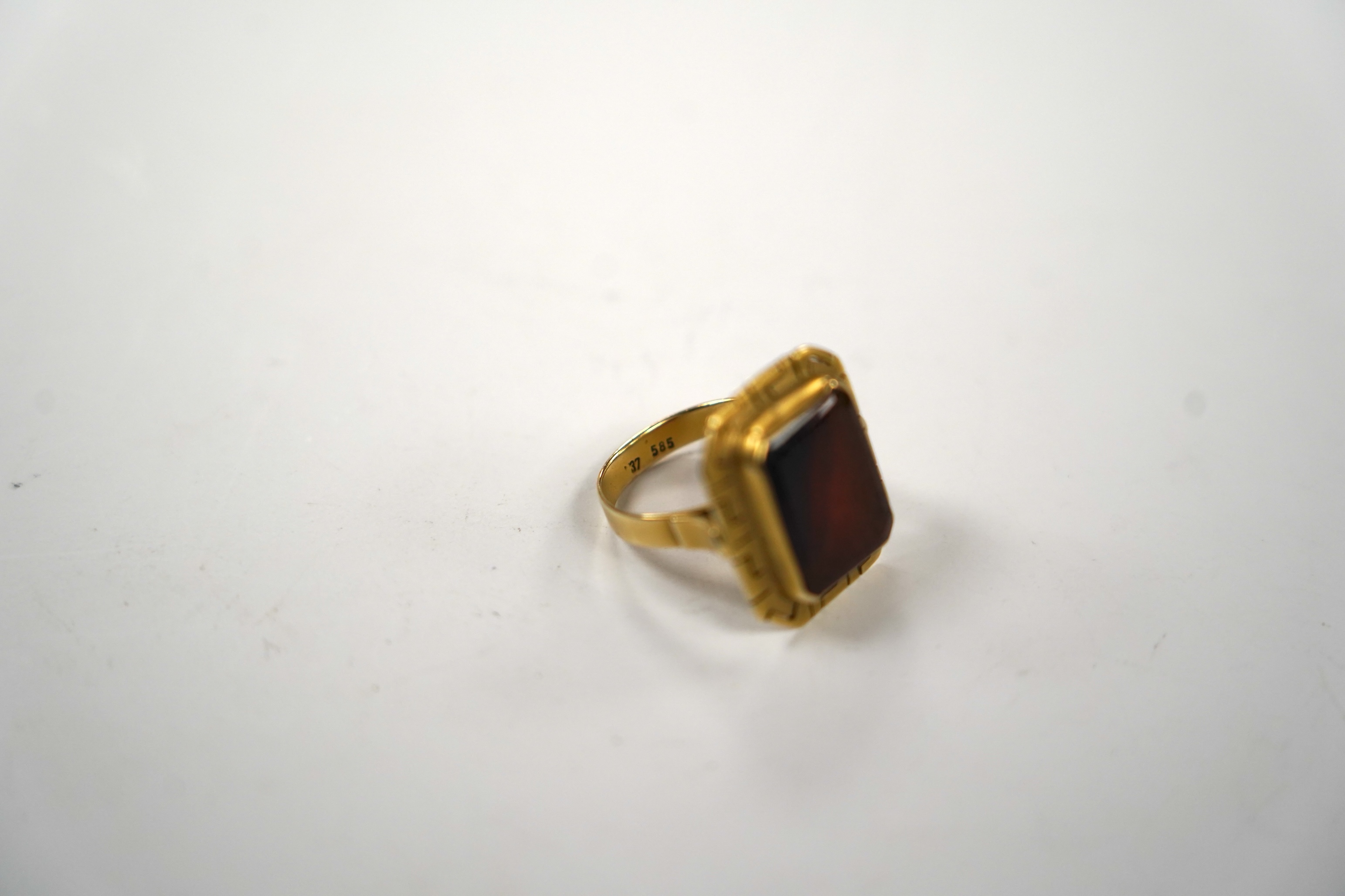 A 14k and carnelian set ring, with pierced border and stone inscribed with Islamic script, size O, gross weight 5.8 grams, in an Ilia Lalalounis box.